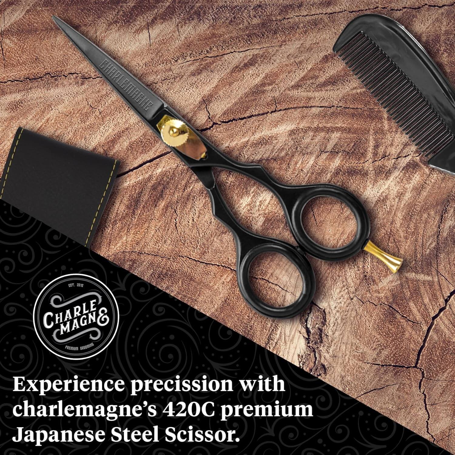 Black hair scissors with gold accents on a wooden surface