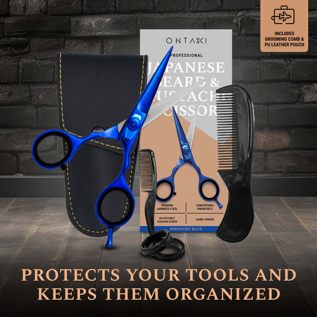 Blue scissors and black comb with packaging on a dark surface 