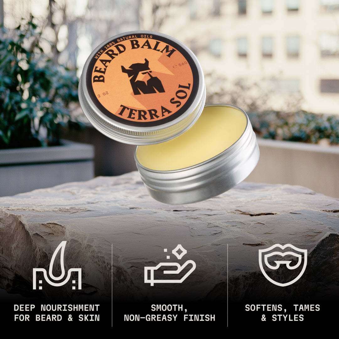 Terra Sol beard balm jar with lid off, displayed on a stone surface outdoors.