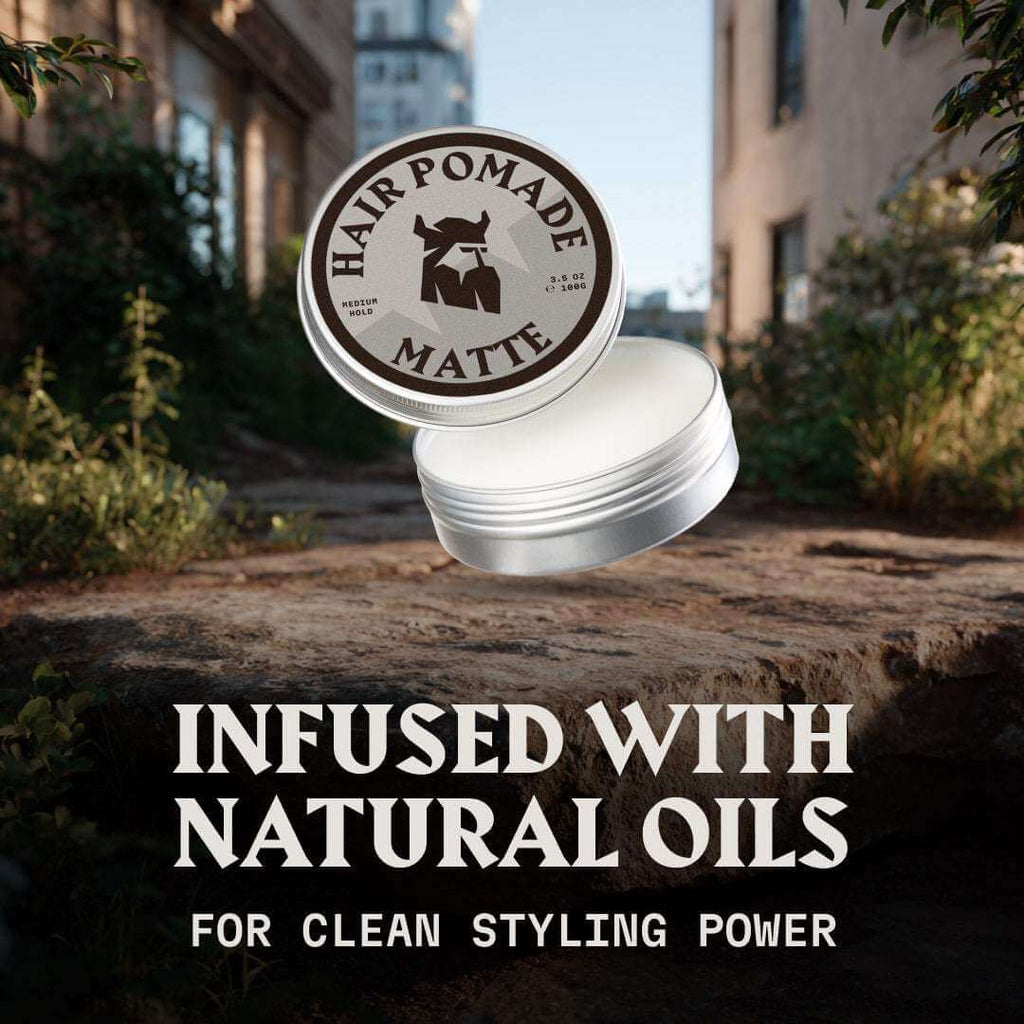 Hair pomade container with 'Infused with Natural Oils' text on a blurred outdoor background