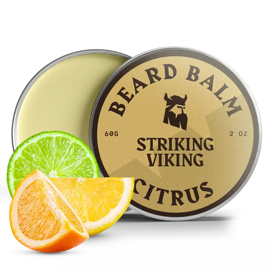 Beard balm container with 'Striking Viking' branding, accompanied by citrus slices on a white background.