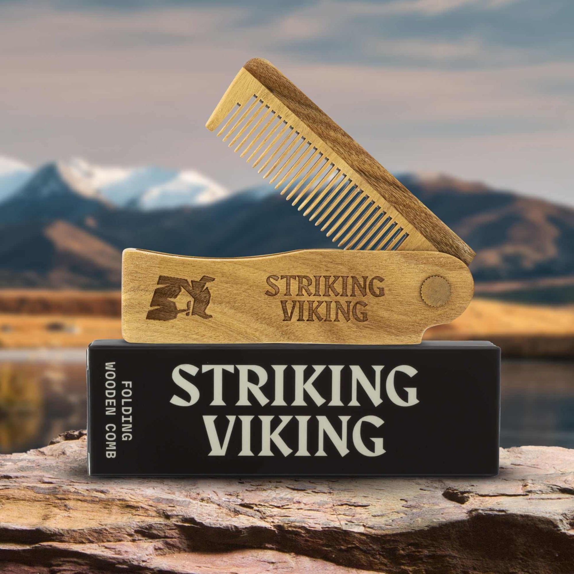 Wooden comb and packaging with 'Striking Viking' branding against a mountainous landscape.